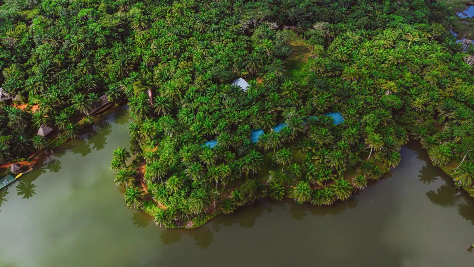 The Magoroto lake held inside unbroken forest, seen from the air